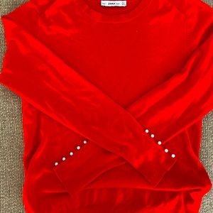 Red sweater with pearl detail